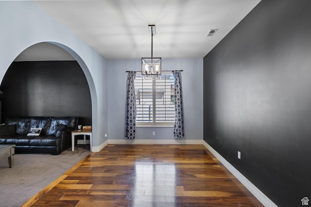 4467 W 5850 S, Hooper, UT 84315 - unfurnished living room featuring a chandelier, wood finished floors, and arched walkways