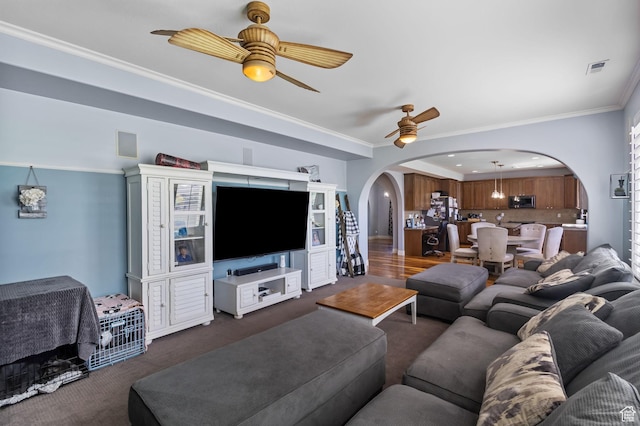 4467 W 5850 S, Hooper, UT 84315 - living area with arched walkways, a ceiling fan, dark colored carpet, and crown molding