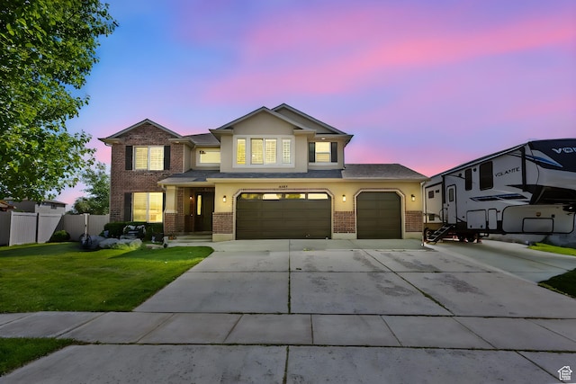 4467 W 5850 S, Hooper, UT 84315 - traditional home with brick siding, driveway, stucco siding, and an attached garage