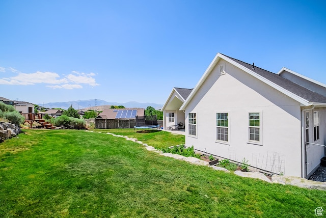 3698 E Butterfield Rd, Eagle Mountain, UT 84005 - view of yard with a trampoline and a mountain view