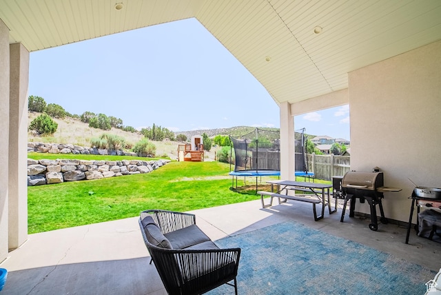 3698 E Butterfield Rd, Eagle Mountain, UT 84005 - view of patio with a trampoline, a playground, and grilling area