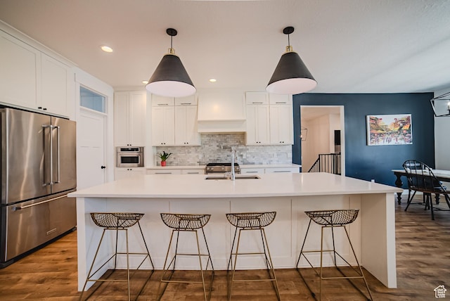 3698 E Butterfield Rd, Eagle Mountain, UT 84005 - kitchen with stainless steel appliances, premium range hood, decorative backsplash, white cabinets, and recessed lighting