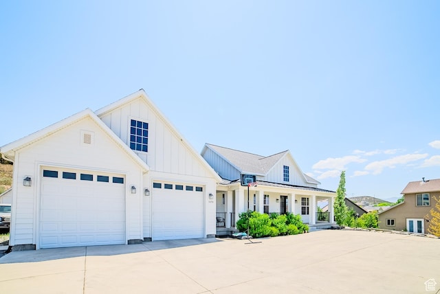 3698 E Butterfield Rd, Eagle Mountain, UT 84005 - modern farmhouse style home with board and batten siding, covered porch, concrete driveway, and a garage