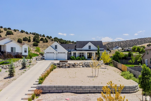 3698 E Butterfield Rd, Eagle Mountain, UT 84005 - modern farmhouse style home featuring an attached garage, a residential view, and driveway