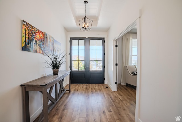 3698 E Butterfield Rd, Eagle Mountain, UT 84005 - entrance foyer with french doors, a chandelier, and wood-type flooring