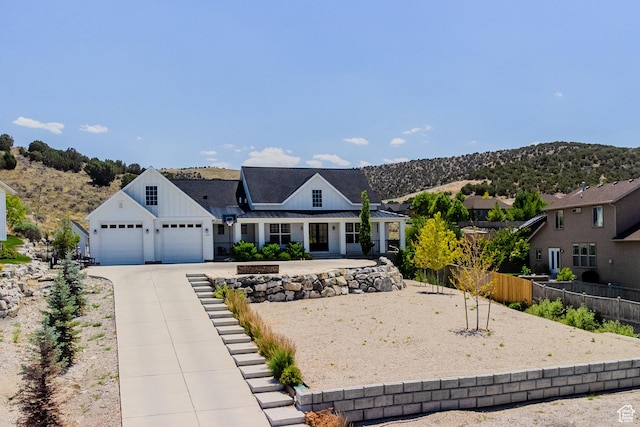 3698 E Butterfield Rd, Eagle Mountain, UT 84005 - modern inspired farmhouse featuring concrete driveway, board and batten siding, an attached garage, and a mountain view