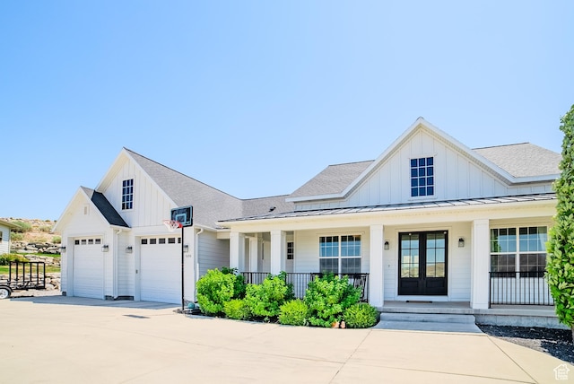3698 E Butterfield Rd, Eagle Mountain, UT 84005 - modern farmhouse style home featuring a porch, a garage, board and batten siding, and concrete driveway