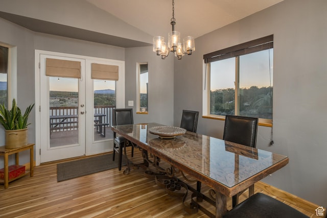 599 S Hideaway Cv S, Monticello, UT 84535 - dining area featuring a chandelier, light wood finished floors, vaulted ceiling, and french doors