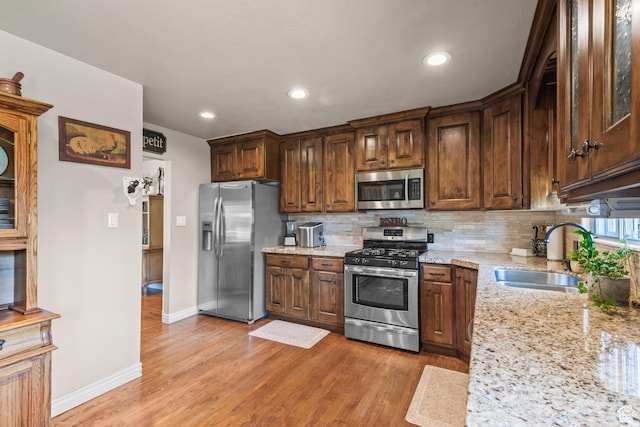 715 S 900 E, Orem, UT 84097 - kitchen with stainless steel appliances, light stone countertops, decorative backsplash, light wood finished floors, and recessed lighting