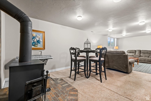 715 S 900 E, Orem, UT 84097 - dining room with carpet floors, a textured ceiling, and a wood stove