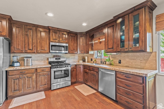 715 S 900 E, Orem, UT 84097 - kitchen with appliances with stainless steel finishes, wood finished floors, plenty of natural light, tasteful backsplash, and recessed lighting