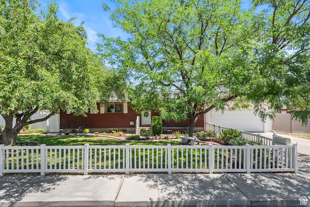 715 S 900 E, Orem, UT 84097 - view of property hidden behind natural elements with a fenced front yard, driveway, and brick siding