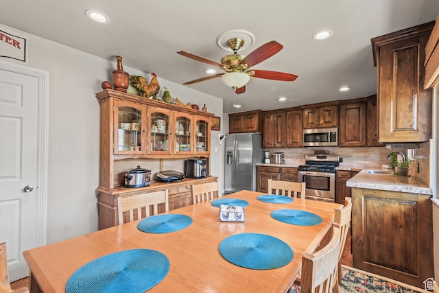 715 S 900 E, Orem, UT 84097 - kitchen with stainless steel appliances, a ceiling fan, light countertops, backsplash, and recessed lighting