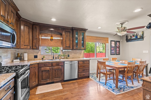 715 S 900 E, Orem, UT 84097 - kitchen featuring appliances with stainless steel finishes, light wood-style flooring, backsplash, a ceiling fan, and recessed lighting