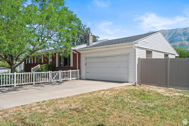 715 S 900 E, Orem, UT 84097 - single story home with a garage, driveway, a fenced front yard, and a chimney