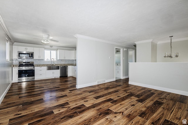 3320 N Plain City Rd W, Plain City, UT 84404 - unfurnished living room with ceiling fan, dark wood-type flooring, ornamental molding, and a chandelier