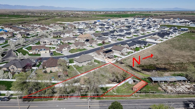 3320 N Plain City Rd W, Plain City, UT 84404 - aerial perspective of suburban area with property parcel outlined and mountains