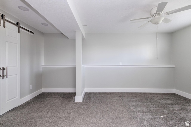 3320 N Plain City Rd W, Plain City, UT 84404 - carpeted empty room with a barn door, ceiling fan, and a textured ceiling