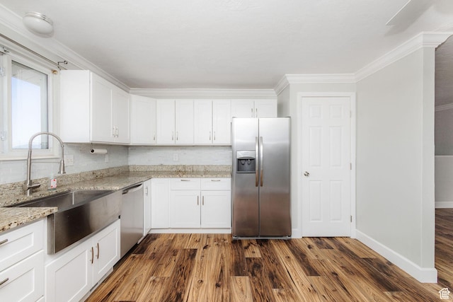3320 N Plain City Rd W, Plain City, UT 84404 - kitchen featuring appliances with stainless steel finishes, crown molding, light stone counters, dark wood-type flooring, and white cabinets