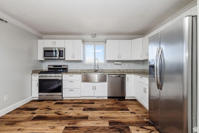3320 N Plain City Rd W, Plain City, UT 84404 - kitchen featuring appliances with stainless steel finishes, ornamental molding, white cabinets, and light stone countertops
