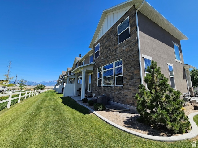 5958 W 8100 S, West Jordan, UT 84081 - back of property featuring stone siding, a mountain view, and board and batten siding