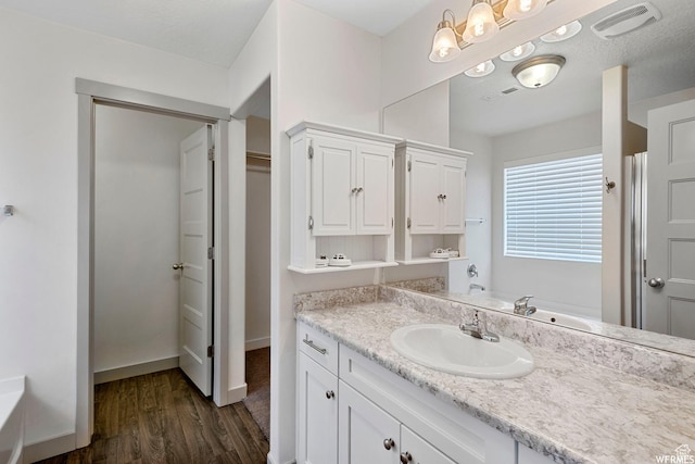 5958 W 8100 S, West Jordan, UT 84081 - bathroom with wood finished floors, vanity, and a closet