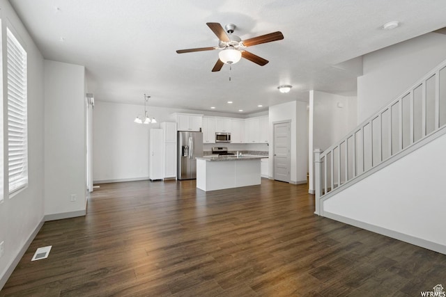 5958 W 8100 S, West Jordan, UT 84081 - unfurnished living room featuring ceiling fan, a chandelier, stairs, dark wood finished floors, and recessed lighting