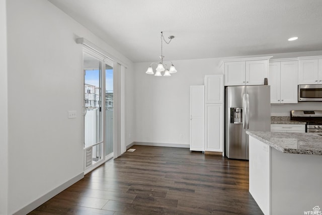 5958 W 8100 S, West Jordan, UT 84081 - kitchen with appliances with stainless steel finishes, light stone counters, dark wood-style floors, white cabinetry, and a chandelier