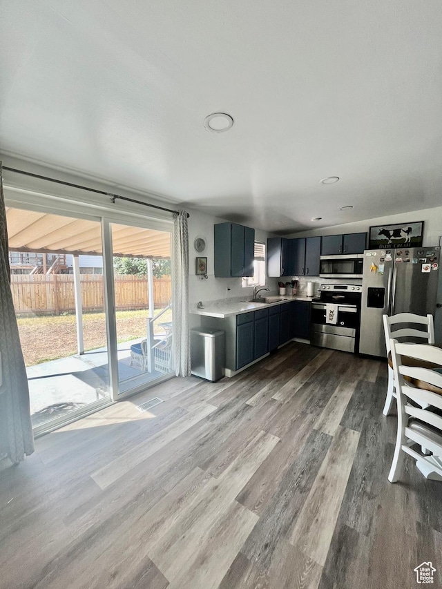 3917 S David Pl, West Valley City, UT 84119 - kitchen with appliances with stainless steel finishes, dark wood-style floors, light countertops, and dark cabinets