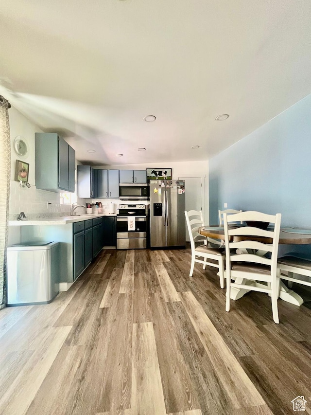 3917 S David Pl, West Valley City, UT 84119 - kitchen featuring appliances with stainless steel finishes, light wood-style floors, light countertops, and recessed lighting