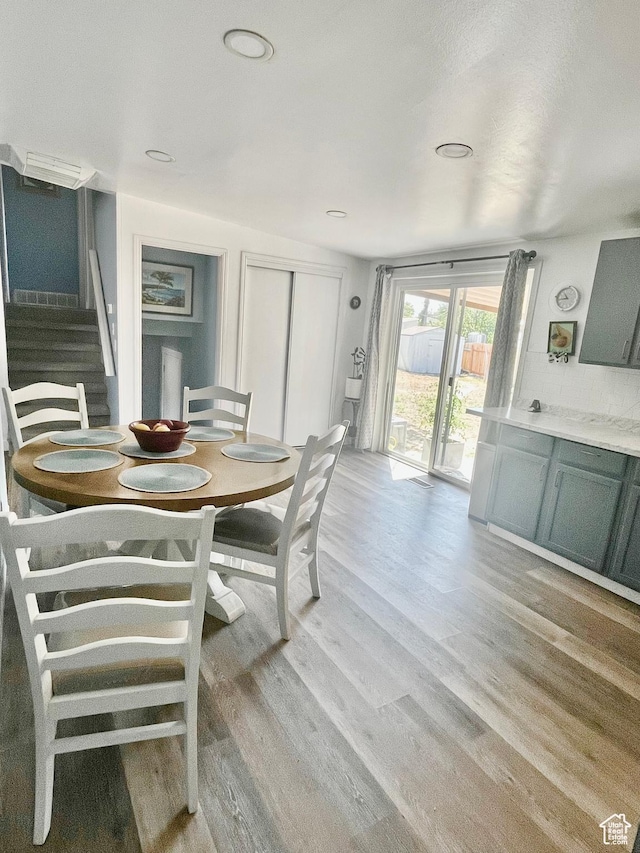 3917 S David Pl, West Valley City, UT 84119 - dining space with light wood-type flooring and stairs