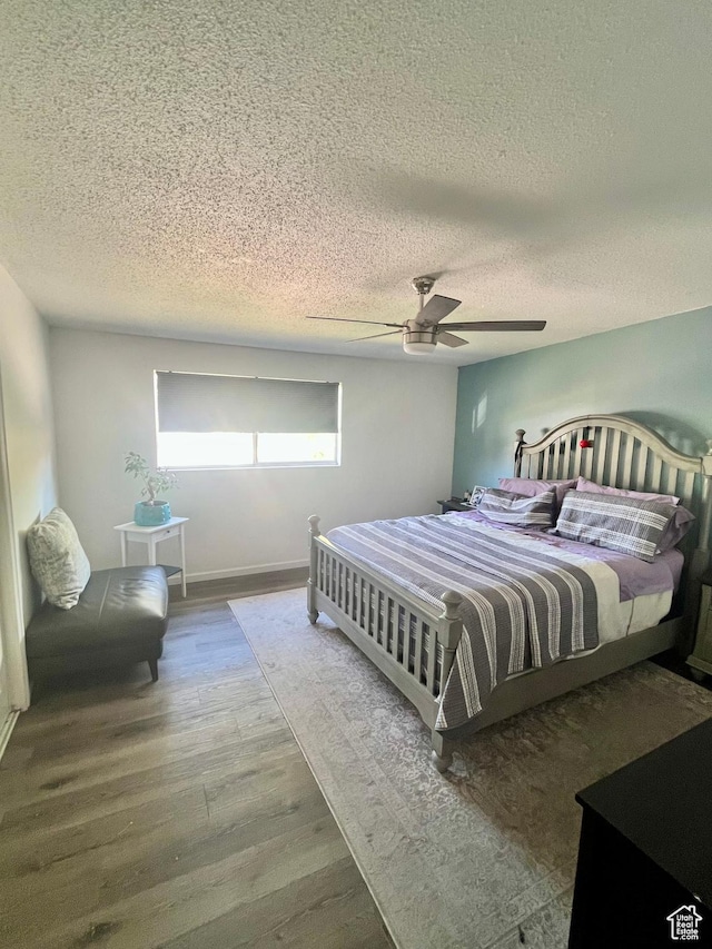 3917 S David Pl, West Valley City, UT 84119 - bedroom featuring wood finished floors, a textured ceiling, and a ceiling fan