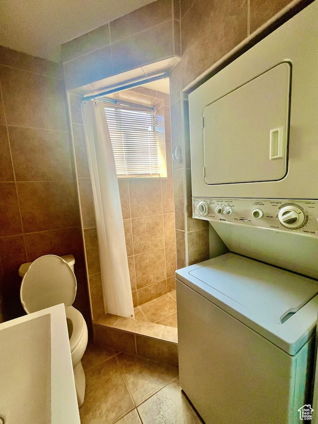 3917 S David Pl, West Valley City, UT 84119 - laundry room with stacked washer / drying machine, tile patterned flooring, and tile walls