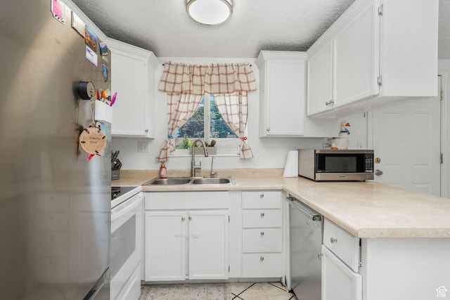 4245 S 3760 W, West Valley City, UT 84120 - kitchen featuring stainless steel appliances, light countertops, white cabinets, and a peninsula