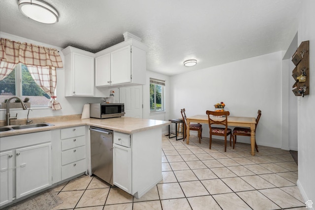 4245 S 3760 W, West Valley City, UT 84120 - kitchen with appliances with stainless steel finishes, white cabinets, light countertops, light tile patterned floors, and a textured ceiling