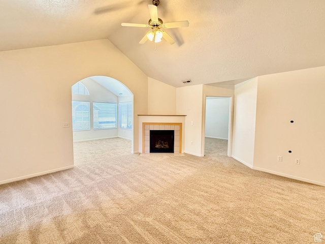 532 W 300 S Unit B, Springville, UT 84663 - unfurnished living room featuring carpet flooring, ceiling fan, vaulted ceiling, a tile fireplace, and a textured ceiling
