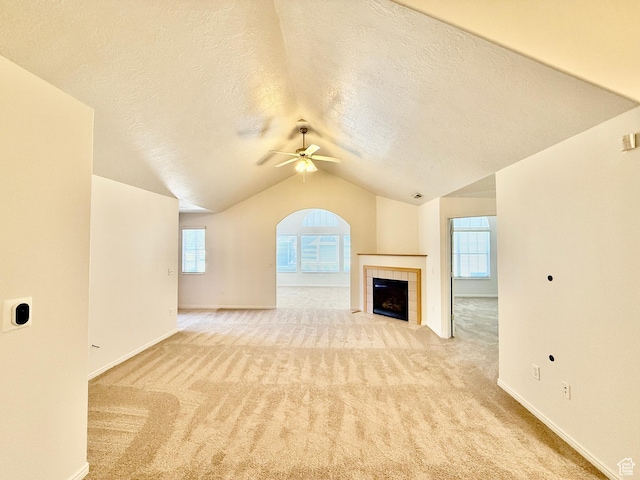 532 W 300 S Unit B, Springville, UT 84663 - unfurnished living room featuring a textured ceiling, a ceiling fan, lofted ceiling, light colored carpet, and a tiled fireplace