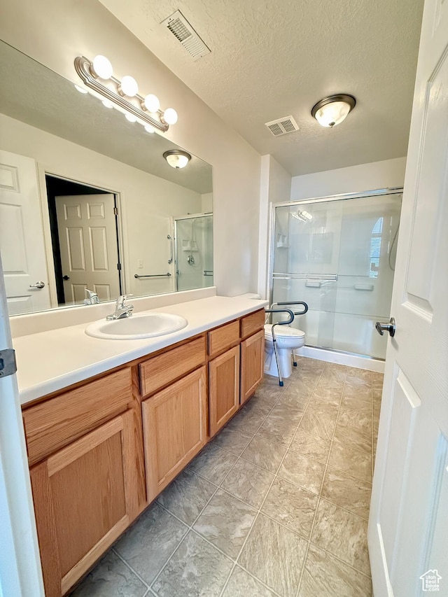 532 W 300 S Unit B, Springville, UT 84663 - bathroom featuring vanity, a shower with shower door, a textured ceiling, and tile patterned floors