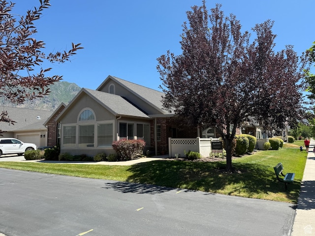 532 W 300 S Unit B, Springville, UT 84663 - view of front facade with a front yard, brick siding, and a garage