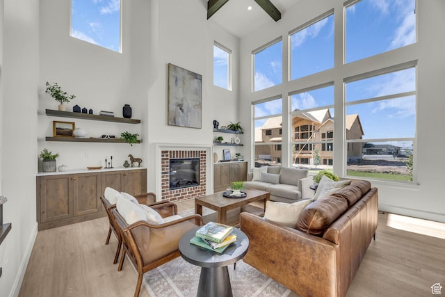 3728 W Chalgrove Rd, Taylor, UT 84401 - living area with a towering ceiling, light wood finished floors, healthy amount of natural light, a brick fireplace, and beam ceiling