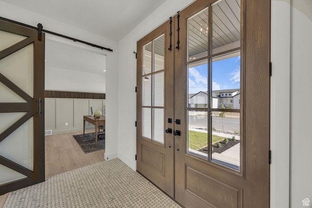 3728 W Chalgrove Rd, Taylor, UT 84401 - entryway with a barn door, wood finished floors, and french doors