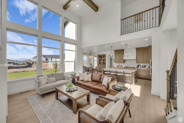 3728 W Chalgrove Rd, Taylor, UT 84401 - living room with light wood finished floors, a high ceiling, beam ceiling, and stairway