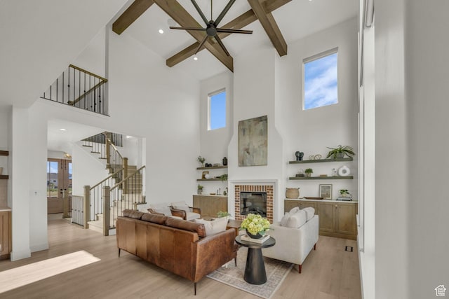 3728 W Chalgrove Rd, Taylor, UT 84401 - living area with a towering ceiling, light wood finished floors, stairway, a ceiling fan, and beamed ceiling