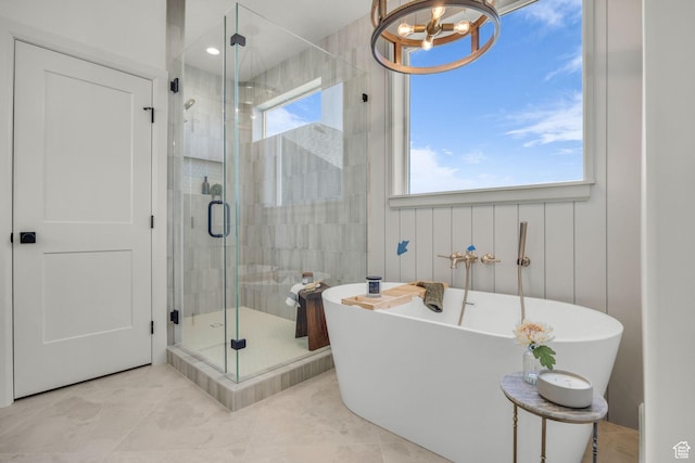 3728 W Chalgrove Rd, Taylor, UT 84401 - bathroom featuring a chandelier, a freestanding tub, a shower stall, and tile patterned floors