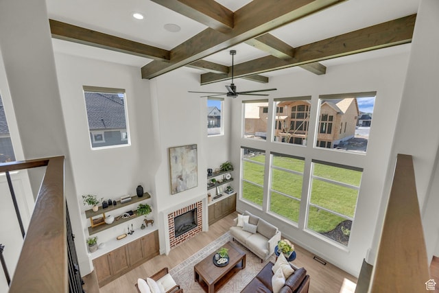 3728 W Chalgrove Rd, Taylor, UT 84401 - living room featuring beam ceiling, wood finished floors, a fireplace, ceiling fan, and recessed lighting
