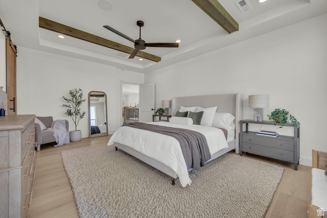 3728 W Chalgrove Rd, Taylor, UT 84401 - bedroom featuring a tray ceiling, a barn door, light wood-style flooring, recessed lighting, and beamed ceiling
