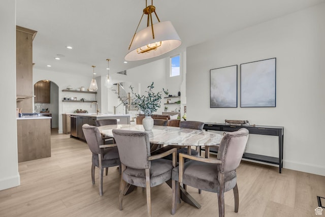 3728 W Chalgrove Rd, Taylor, UT 84401 - dining area featuring stairway, light wood-type flooring, recessed lighting, and arched walkways