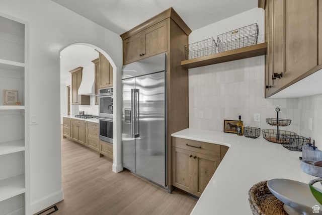 3728 W Chalgrove Rd, Taylor, UT 84401 - kitchen featuring stainless steel appliances, open shelves, light wood-type flooring, backsplash, and light countertops