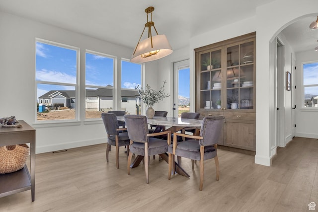 3728 W Chalgrove Rd, Taylor, UT 84401 - dining room with light wood-type flooring and arched walkways