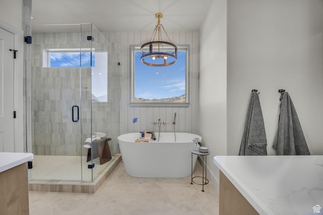 3728 W Chalgrove Rd, Taylor, UT 84401 - full bathroom featuring a freestanding bath, a shower stall, a chandelier, vanity, and tile patterned flooring
